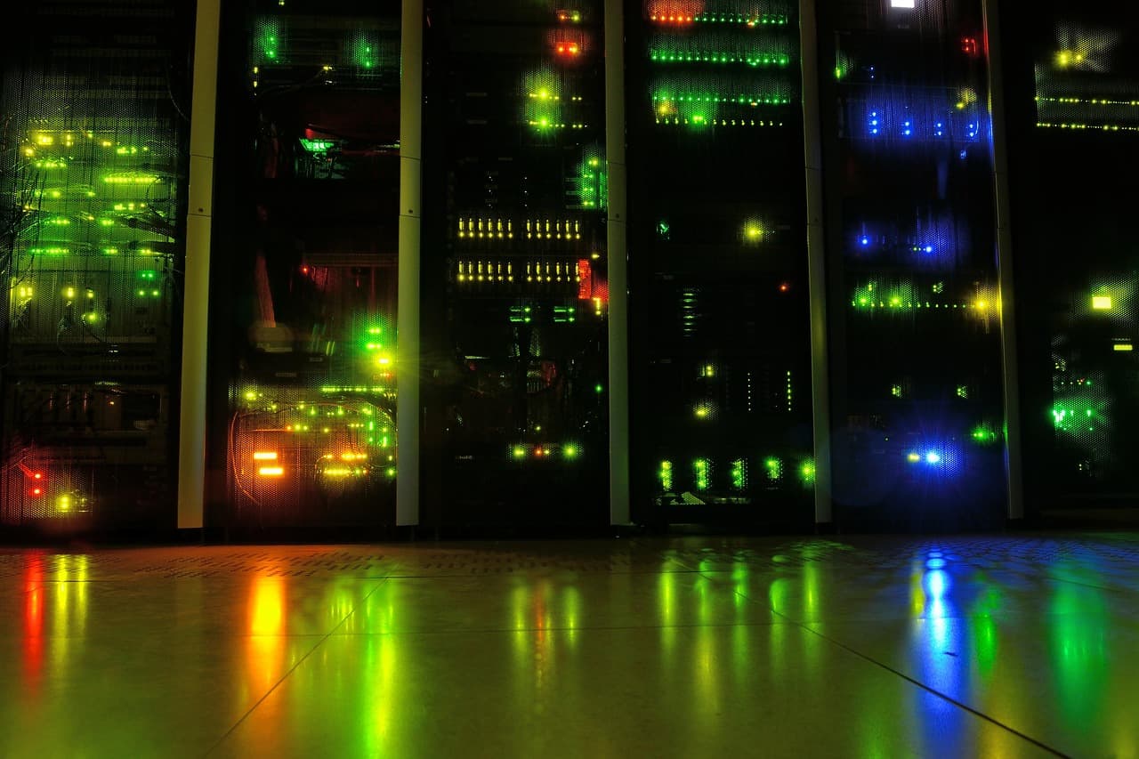 Server room racks with status lights in a dark data center