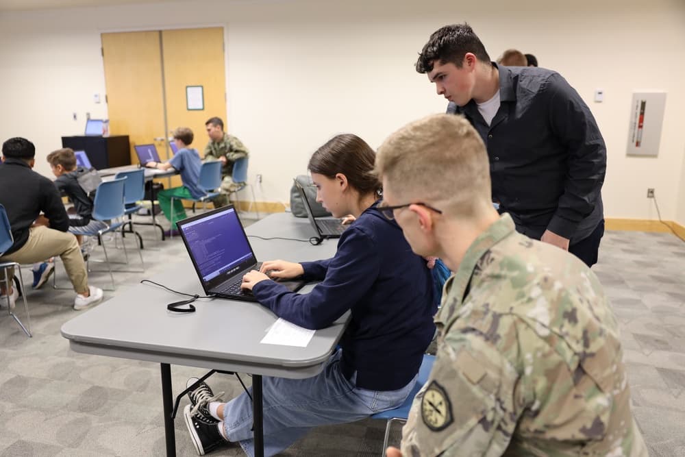 Participants working on laptops during a Capture-the-Flag cybersecurity competition